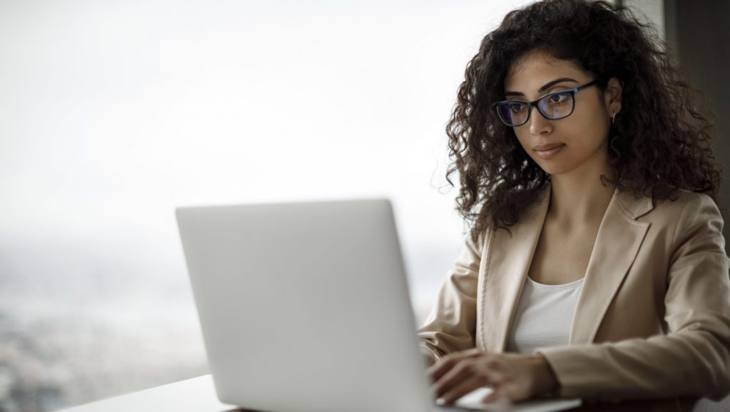 A women sitting in front of a laptop