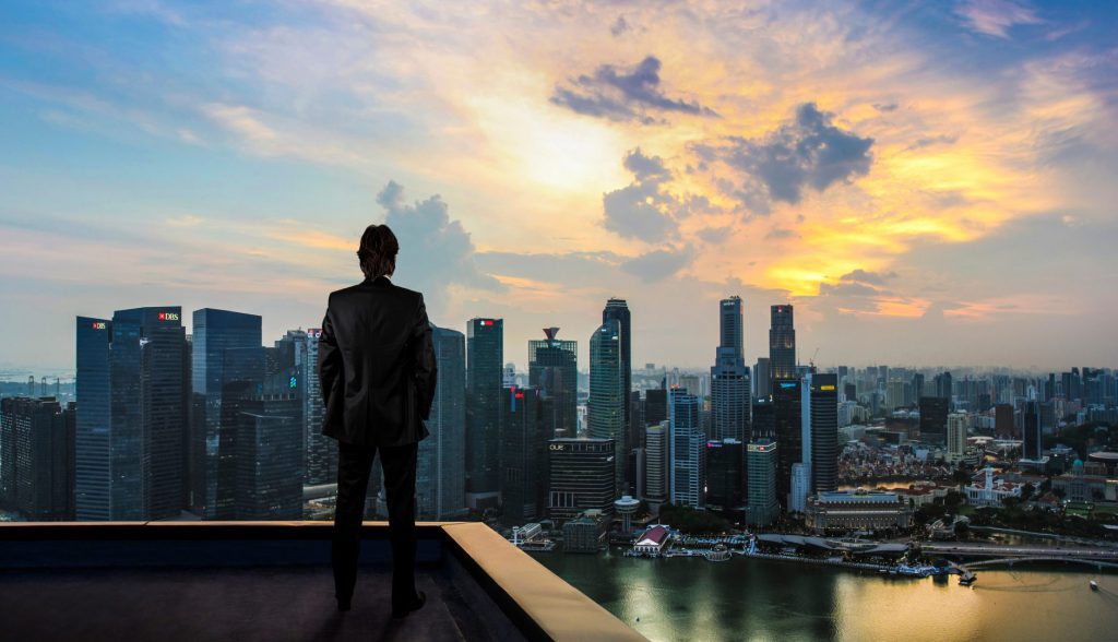 A man standing on the roof and watching a city skyline