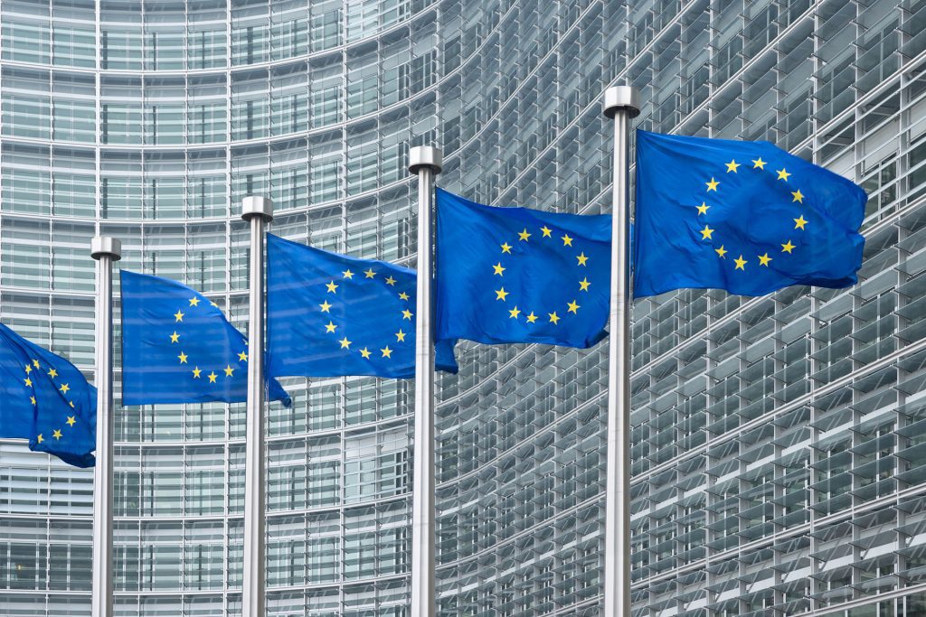 Flags in front of the European Union Parliament building in Brussels