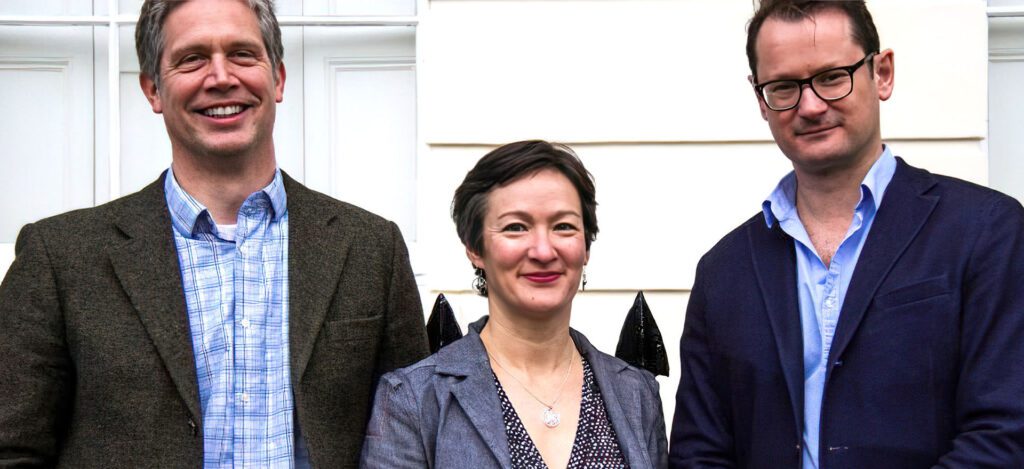 Christoph Geppert, Madelyn Postman and Charlie Pryor in front of the building.